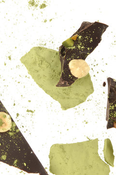 Black chocolate with almonds, hazelnuts, walnuts and pistachios and matcha powdered green tea
