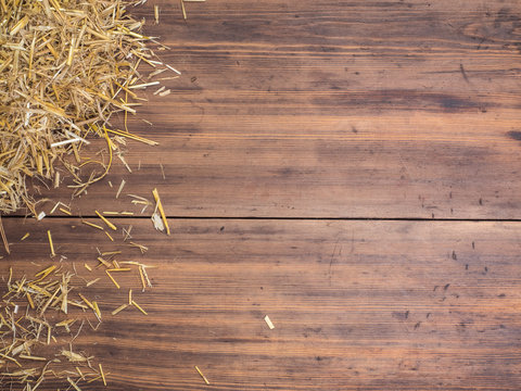 Rural eco background with and straw on the background of old wooden planks. The view from the top. Creative background for greeting cards, menu or advertising