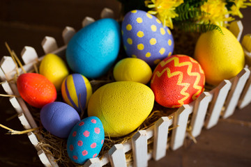 Colorful easter decorative eggs in wooden box