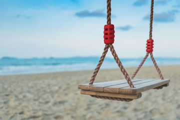 Wooden swing on tropical beach