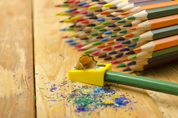 Sharp pencils on a wooden background