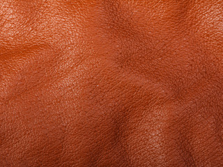 Orange leather in folds background