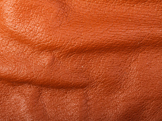 Orange leather in folds background