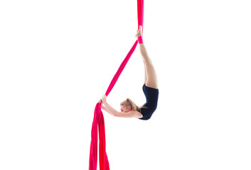 Woman hanging in aerial silks, isolated on white