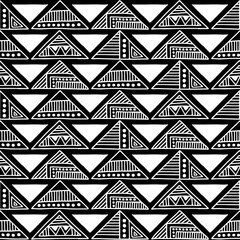Seamless vector pattern. Black and white geometrical background with hand drawn decorative tribal elements. Print with ethnic, folk, traditional motifs. Graphic vector illustration.