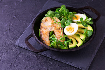 Grilled sheatfish fish steak with avocado, arugula and salad