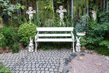 iron bench in garden with small plant background