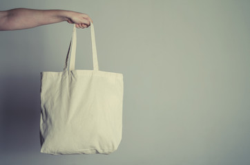 Mock-up cotton handmade eco shopping bag in hand