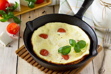 Breakfast background. Scrambled eggs with fresh tomatoes and suluguni cheese. The concept of a healthy diet and diet.