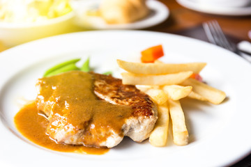 pork chop with dilicious sauce and french fries