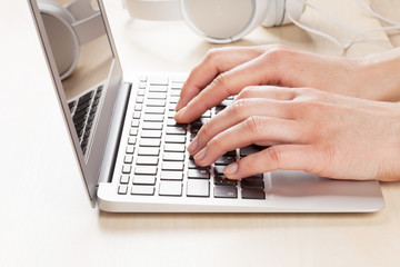 Woman working on laptop. Hands typing on keyboard.