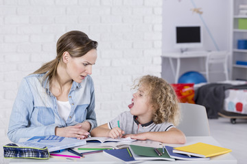 Boy sticking tongue at mother