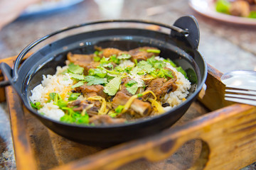 Thai food Roasted pork with jasmine rice with fresh green cilantro or coriander leaves.