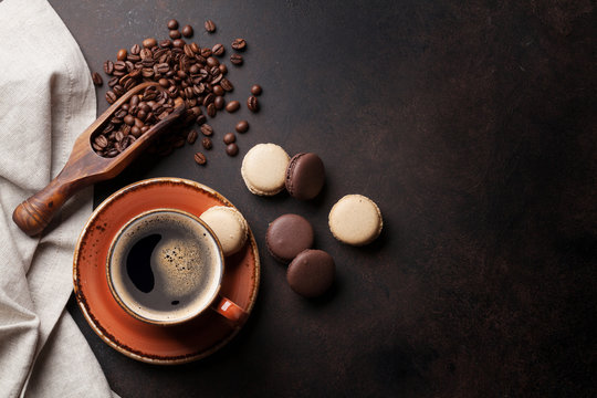 Coffee cup and macaroons on old kitchen table