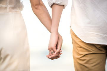 Couple holding hands - Powered by Adobe