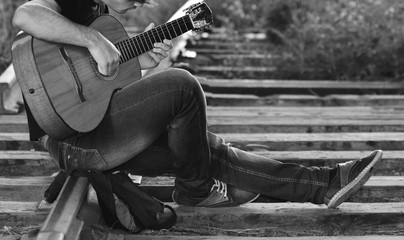 Fototapeta na wymiar Railway blues. Young man playing guitar on the railway