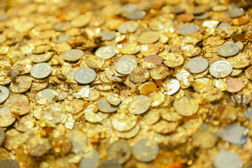 Closeup Golden plate foil with coin at Thai Temple Buddha Statue skin surface.