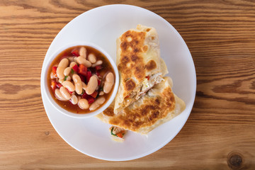 Mexican cuisine, burrito with garnish of beans