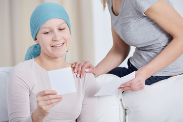 Woman with cancer looking at photo