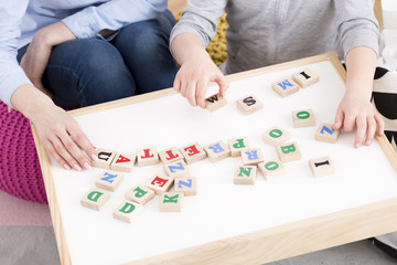 Woman and girl playing with building blocks