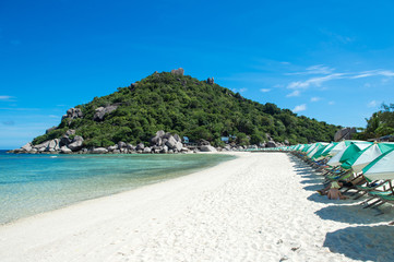Beautiful beach with chairs and umbrellas