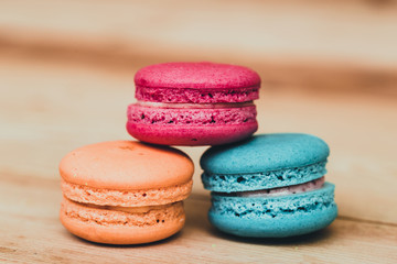 Macaron sweet dessert on wood background dark tone.