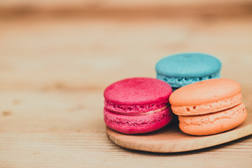 Macaron sweet dessert on wood background dark tone.