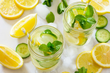 Refreshing summer drink with lemon and cucumber on a background of stone. The concept of eating...