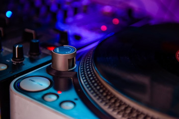 Fototapeta na wymiar Close up Professional DJ audio equipment - turntable vinyl record player, selective focus.Sound technology for disc jockey to play at concert,party,event
