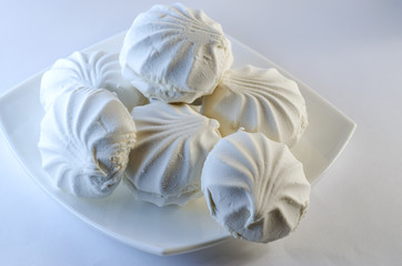 Marshmallow in a plate on a white background