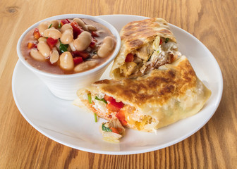 Mexican cuisine, burrito with garnish of beans