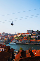 Fototapeta na wymiar Tiled roofs in Porto. The Douro River. Summer city landscape.