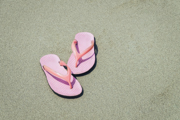 Fototapeta na wymiar Abstract pink shoes on beach and sand, vacation and holiday concept, with copy space