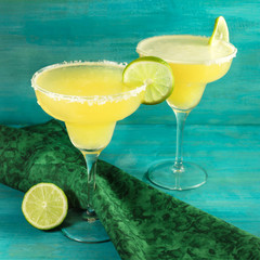 Lemon Margarita cocktails with limes and copyspace