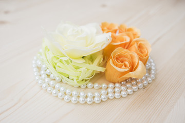 Roses flowers with pearls on a wood background 