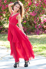 Obraz na płótnie Canvas Woman in a red dress outside