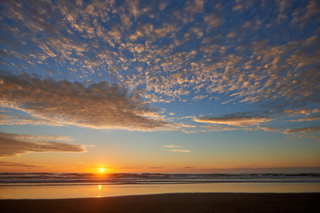Naklejka na ściany i meble Oregon Coast at Sunset. View of a scenic sky and ocean near Barview Jetty. USA Pacific Northwest.