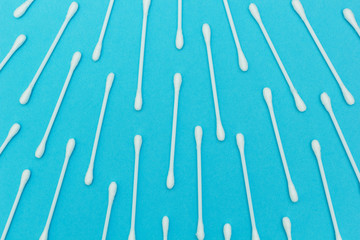 Background of cotton buds on a blue background.