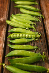 fresh green peas on the wooden table