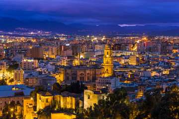 Malaga cathedral and cityscape at twilight