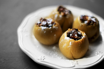 Baked apples with raisins and nuts on a plate