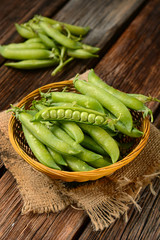 fresh green peas on the wooden table