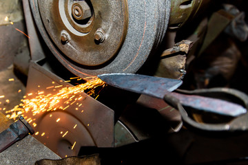 Blacksmith, knife sharpening, sparks, metal.