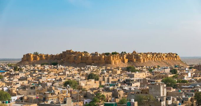Jaisalmer cityscape from sunset to twilight, time lapse. The majestic fort dominating the desert city like a sand castle. Travel destination in Rajasthan, India.