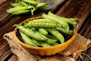 fresh green peas on the wooden table