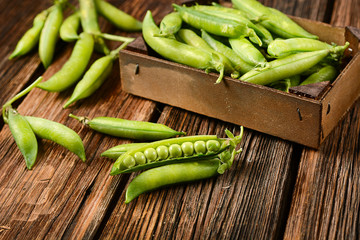 fresh green peas on the wooden table