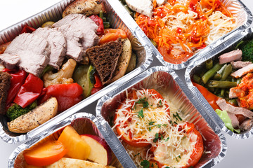 Healthy food take away in boxes, top view at wood