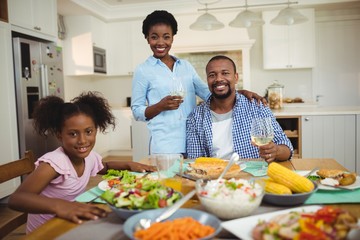 Portrait of family having meal on dinning table at home
