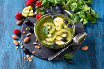 Smoothie bowl,  green smoothie with berries, healthy breakfast, vegan vitamin snack