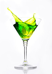 A glass with green cocktail on a white background.